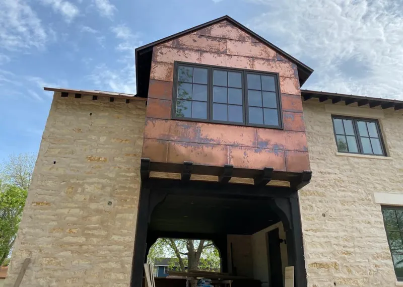 Copper metal panel facade on a stone building for Metal Roof Coating in Delta